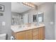 Bathroom vanity featuring double sinks and modern light fixture at 722 Chepstow Ave, Las Vegas, NV 89178