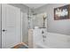 Bright bathroom featuring a glass-enclosed shower and separate soaking tub at 722 Chepstow Ave, Las Vegas, NV 89178
