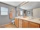 Bathroom with a double sink vanity with tile floors and a neutral color scheme at 722 Chepstow Ave, Las Vegas, NV 89178