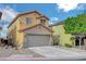 Inviting home featuring a two-car garage and landscaped front yard, creating a welcoming curb appeal at 722 Chepstow Ave, Las Vegas, NV 89178