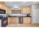 Well-lit kitchen with modern appliances, wooden cabinets, and a functional layout for easy cooking at 722 Chepstow Ave, Las Vegas, NV 89178