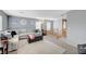 Living room area showcasing a large sectional, carpet, and ample lighting at 722 Chepstow Ave, Las Vegas, NV 89178
