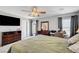Comfortable main bedroom has a ceiling fan, desk, and balcony access at 722 Chepstow Ave, Las Vegas, NV 89178