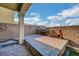 Brick-paved patio with privacy walls, decorative sunburst, and patio table with desert view at 722 Chepstow Ave, Las Vegas, NV 89178