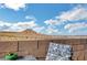 Desert landscape view from backyard patio, with privacy wall and patio furniture at 722 Chepstow Ave, Las Vegas, NV 89178