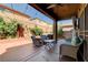 Inviting covered patio with comfortable seating and a relaxing hot tub in a well-landscaped backyard at 7613 Pulpit Rock Ct, Las Vegas, NV 89166