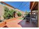 Backyard featuring a spacious patio, hot tub, string lights, and lush greenery at 7613 Pulpit Rock Ct, Las Vegas, NV 89166