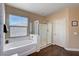 Bathroom featuring a soaking tub, separate shower, and wood flooring at 7613 Pulpit Rock Ct, Las Vegas, NV 89166