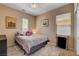 Cozy bedroom with neutral paint, stylish bedspread, wood look flooring, and plenty of natural light at 7613 Pulpit Rock Ct, Las Vegas, NV 89166