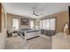 Spacious bedroom with a ceiling fan, large window and carpet at 7613 Pulpit Rock Ct, Las Vegas, NV 89166