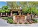 Elegant entrance to The Club at the community, surrounded by lush plants and stone accents at 7613 Pulpit Rock Ct, Las Vegas, NV 89166