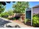 Community sign with 'Providence' welcomes residents with park rules, nestled amid lush trees and landscaping at 7613 Pulpit Rock Ct, Las Vegas, NV 89166
