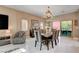 Elegant dining room with designer chandelier, modern décor, and sliding glass doors to the backyard at 7613 Pulpit Rock Ct, Las Vegas, NV 89166