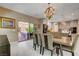 Elegant dining area with modern chandelier, patio access, and kitchen view at 7613 Pulpit Rock Ct, Las Vegas, NV 89166