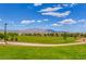 Expansive green space with walking path and mountain views providing a serene outdoor recreation area at 7613 Pulpit Rock Ct, Las Vegas, NV 89166