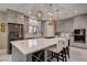 Bright kitchen with white marble countertops, stainless steel appliances, gray cabinetry, and decorative pendant lighting at 7613 Pulpit Rock Ct, Las Vegas, NV 89166