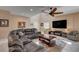 Comfortable living room features a large sectional sofa, ceiling fan, and modern entertainment center at 7613 Pulpit Rock Ct, Las Vegas, NV 89166