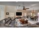 Comfortable living room with a large TV, open floor plan, dining area, and stylish furnishings at 7613 Pulpit Rock Ct, Las Vegas, NV 89166