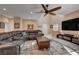 Comfortable living room features a large sectional sofa, ceiling fan, and modern entertainment center at 7613 Pulpit Rock Ct, Las Vegas, NV 89166