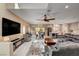 Spacious living room with a large tv, modern furniture, and an open floor plan connecting to the dining area at 7613 Pulpit Rock Ct, Las Vegas, NV 89166