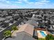 An aerial view showcasing the property with it's private pool nestled in a serene monochrome neighborhood at 7857 Midnight Ride St, Las Vegas, NV 89131