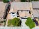 Aerial view of a suburban home featuring lush trees, a driveway, and a two-car garage at 7857 Midnight Ride St, Las Vegas, NV 89131