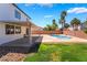 Expansive backyard showcases a pool, patio, lush lawn, and desert landscaping at 7857 Midnight Ride St, Las Vegas, NV 89131