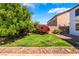 Beautiful backyard landscape featuring a lush lawn and mature plants at 7857 Midnight Ride St, Las Vegas, NV 89131