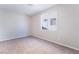 Bright bedroom with neutral walls, carpet, and a large window for natural light at 7857 Midnight Ride St, Las Vegas, NV 89131
