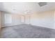 Large carpeted bedroom with two windows and neutral-colored walls, offering a serene retreat at 7857 Midnight Ride St, Las Vegas, NV 89131