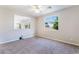 Bright, carpeted bedroom with a large window and a pass-through to another room or living area at 7857 Midnight Ride St, Las Vegas, NV 89131