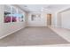 Bright living area with a large window and carpeted flooring at 7857 Midnight Ride St, Las Vegas, NV 89131