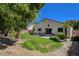 Serene backyard with a patio, green lawn, and mature landscaping around the perimeter at 8041 Villa Rosarito St, Las Vegas, NV 89131