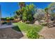 A private backyard with a lawn, patio, trees, and tranquil surroundings at 8041 Villa Rosarito St, Las Vegas, NV 89131