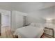 Spare bedroom with wood-look floors, closet with sliding doors, and adjoining bathroom at 8041 Villa Rosarito St, Las Vegas, NV 89131