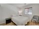 Cozy bedroom with wood-look floors, a large window, and neutral decor for a comfortable space at 8041 Villa Rosarito St, Las Vegas, NV 89131