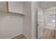 Walk-in closet with wood-look floors, an open rod for hanging clothes, and a doorway to the bathroom at 8041 Villa Rosarito St, Las Vegas, NV 89131