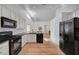 Well-lit kitchen with black appliances, white cabinets, and a skylight at 8041 Villa Rosarito St, Las Vegas, NV 89131
