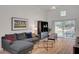 Bright living room with a large gray sofa and sliding glass doors to the backyard at 8041 Villa Rosarito St, Las Vegas, NV 89131