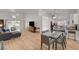 Open-concept living space with hardwood floors and sliding glass doors to the outdoor patio at 8041 Villa Rosarito St, Las Vegas, NV 89131