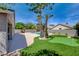 Spacious backyard with a pool, putting green, and lush palm trees at 8080 Black Orchid Ave, Las Vegas, NV 89131