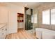 Modern bathroom with glass shower, freestanding tub, and spacious walk-in closet at 8080 Black Orchid Ave, Las Vegas, NV 89131