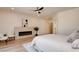 Bright bedroom featuring a modern fireplace, light wood floors, and neutral color scheme at 8080 Black Orchid Ave, Las Vegas, NV 89131