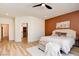 Well-lit bedroom with light wood floors, ceiling fan, and a comfortable aesthetic at 8080 Black Orchid Ave, Las Vegas, NV 89131