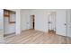 Bright bedroom featuring light wood flooring, walk-in closet, and ensuite bathroom at 8080 Black Orchid Ave, Las Vegas, NV 89131