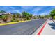 Gated community entrance featuring mature landscaping and secure access for residents and visitors at 8080 Black Orchid Ave, Las Vegas, NV 89131