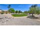 Scenic greenbelt area featuring lush greenery, mature trees, and community pathways at 8080 Black Orchid Ave, Las Vegas, NV 89131