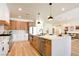Bright kitchen featuring a large island and stainless steel appliances, seamlessly flows to dining area at 8080 Black Orchid Ave, Las Vegas, NV 89131