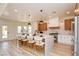 Modern kitchen with white countertops, wooden cabinets, island seating, and stainless steel appliances at 8080 Black Orchid Ave, Las Vegas, NV 89131