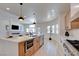 Bright, modern kitchen with stainless steel appliances, a large island, and seamless flow into the living room at 8080 Black Orchid Ave, Las Vegas, NV 89131